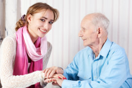 smiling caregiver and old man