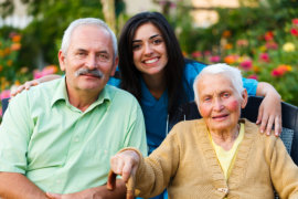 happy old couple and caregiver